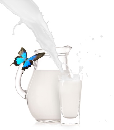 Milk jug with glass over white background の写真素材