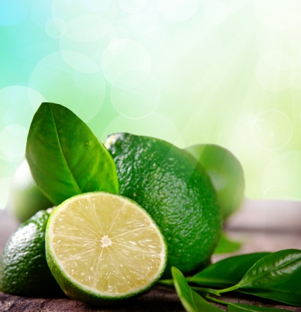 Fresh limes on wooden backgroundの写真素材