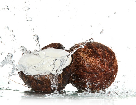 cracked coconut with splashing water の写真素材