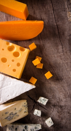 Various types of cheese on wooden backgroundの写真素材