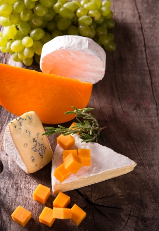 Various types of cheese on wooden backgroundの写真素材