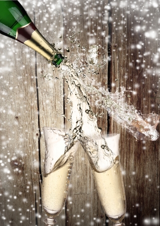 Pair of champagne flutes making a Champagne splashの写真素材