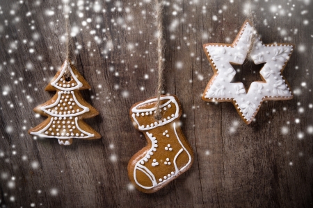 Traditional gingerbread cookies hanging over wooden backgroundの写真素材