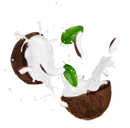 Coconut with milk splash over white の写真素材