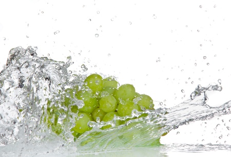 Grapes with water splash over whiteの写真素材