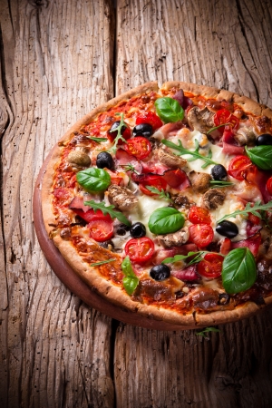 Delicious italian pizza served on wooden tableの写真素材