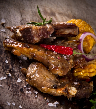 Delicious lamb chops on wooden tableの写真素材