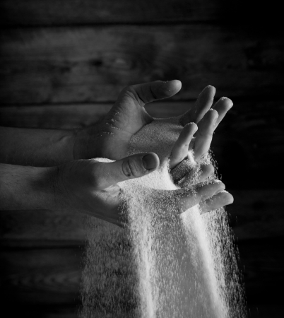 sand running through hands as a symbol for timeの写真素材
