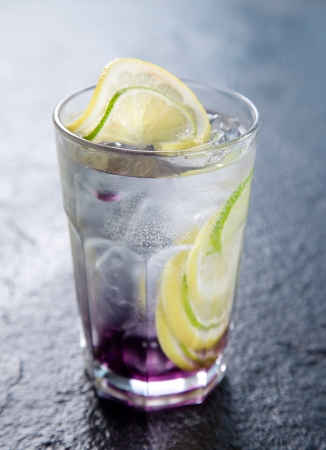 Drink with ice cubes and lime slicesの写真素材