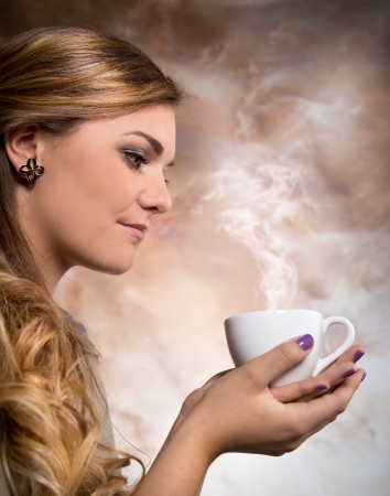 Pretty woman drinking cup of coffeeの写真素材