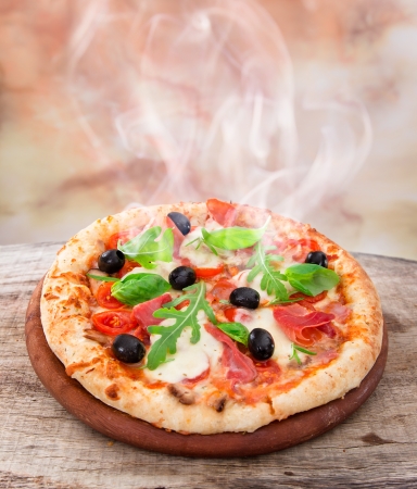 Delicious italian pizza served on wooden tableの写真素材