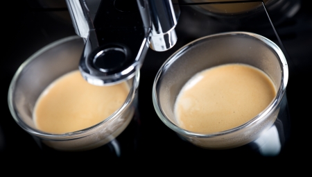 golden espresso flowing into the cupsの写真素材