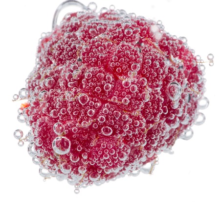 Fresh raspberry in water with bubbles