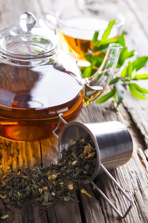 Transparent cup of green tea on wooden backgroundの写真素材