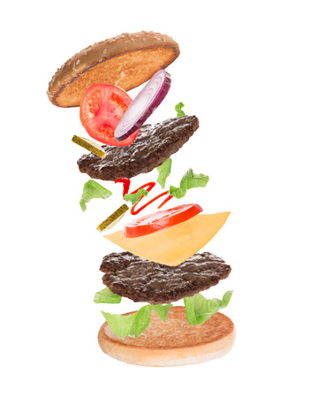 Delicious hamburger with flying ingredients on white の写真素材