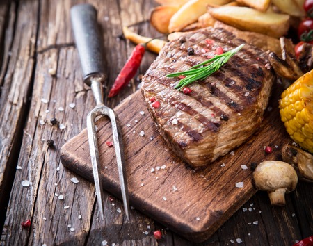 Delicious beef steak on wooden table, close-upの写真素材