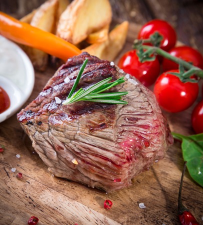 Delicious beef steak on wooden table, close-upの写真素材
