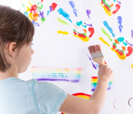 Beautiful little girl painting over whiteの写真素材