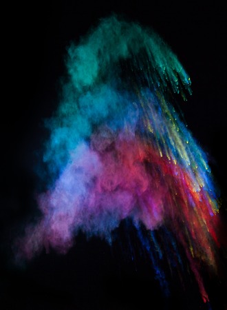 Launched colorful powder, isolated on black backgroundの写真素材