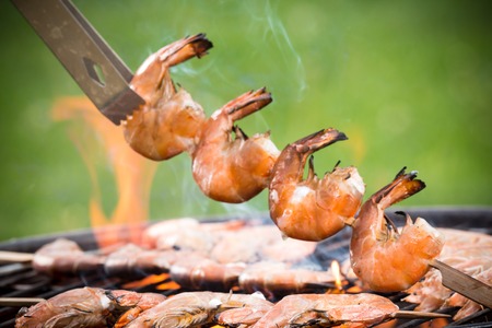 Delicious prawn on grill with flames in backgroundの写真素材