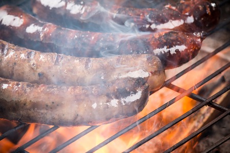 Grilled sausages on the grill, close-up の写真素材