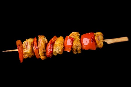 Tasty skewers on black background, close-up 