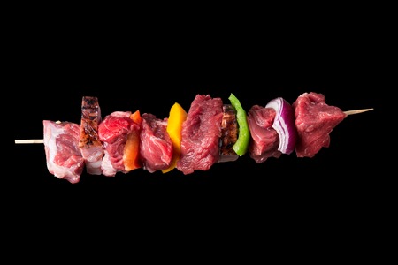 Tasty skewers on black background, close-up の写真素材