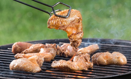 Grilled chicken Legs on the grill, close-up の写真素材