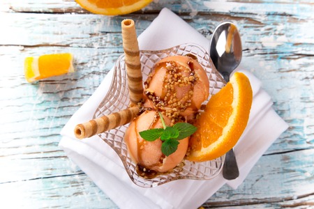 Ice cream scoops on wooden table, close-up の写真素材