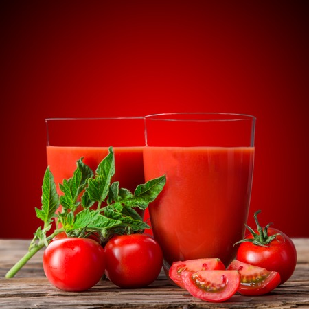 Fresh tomato juice on wooden tableの写真素材