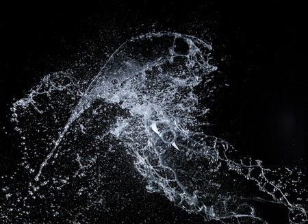 Water splashes over black backgroundの写真素材