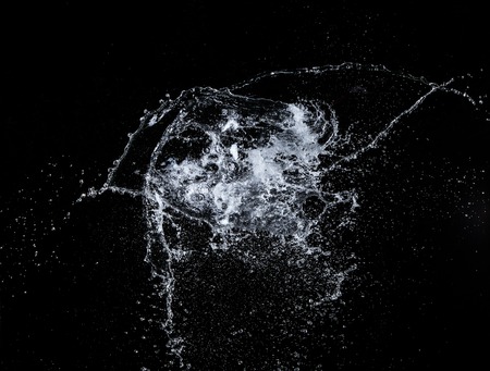 Water splashes over black background