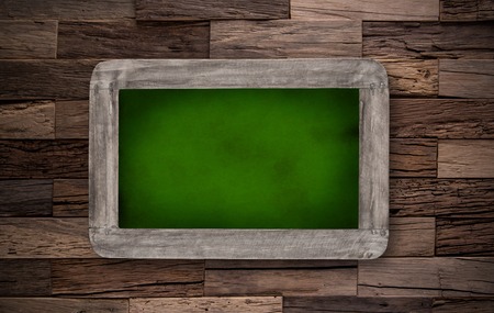 School supplies with blackboard on wooden table, close-up の写真素材