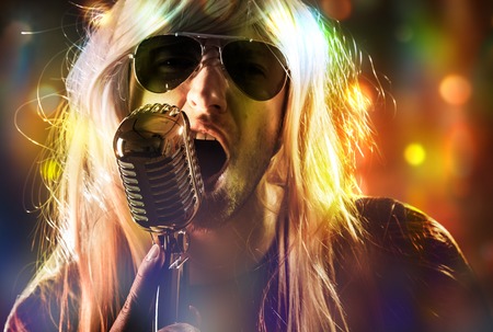 Rock singer screaming on the retro microphoneの写真素材