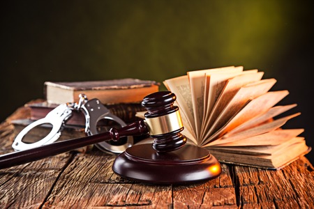 Wooden gavel and books on wooden table, law conceptの写真素材
