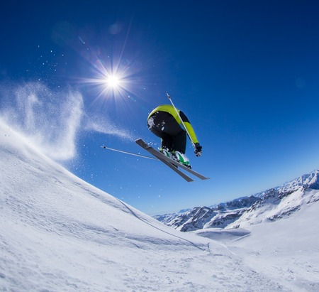 Skier in high mountains during sunny day.の写真素材
