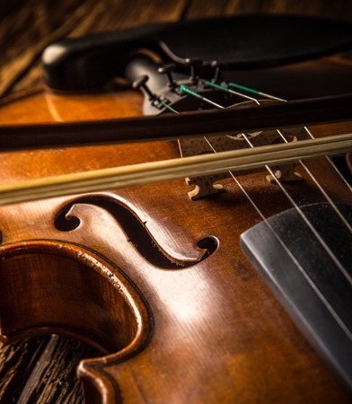 violin in vintage style on wood backgroundの写真素材