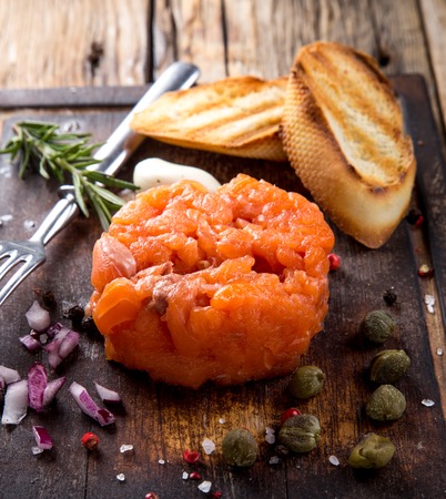 Delicious salmon steak on wooden table, close-upの写真素材