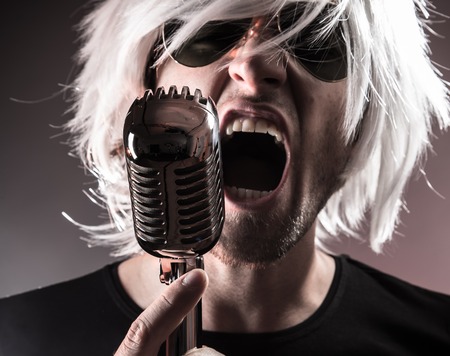 Rock singer screaming on the retro microphoneの写真素材