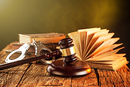 Wooden gavel and books on wooden table, law conceptの写真素材