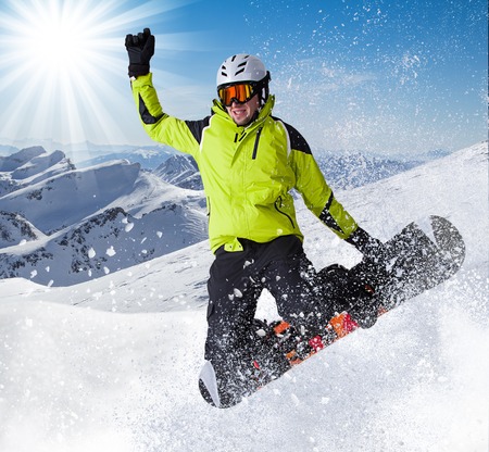 Snowboarder in high mountains during sunny day.の写真素材