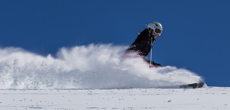 Skier in high mountains during sunny day.の写真素材