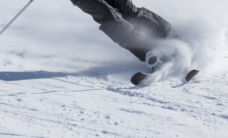 Skier in high mountains during sunny day.の写真素材