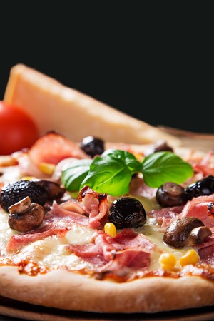 Delicious italian pizza served on wooden table, close-up.の写真素材