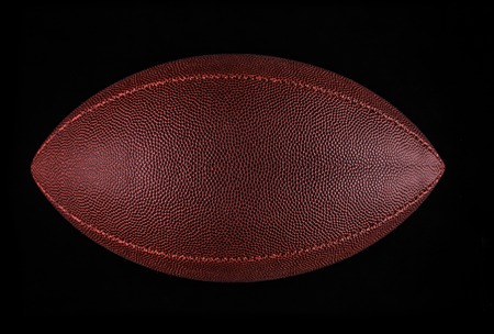flying rugby ball isolated on black.の写真素材
