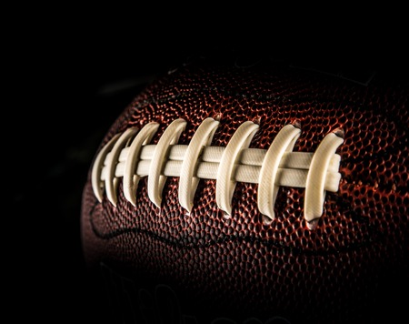 flying rugby ball isolated on black.の写真素材