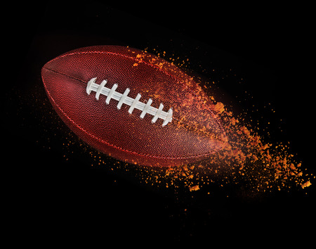 flying rugby ball isolated on black.の写真素材