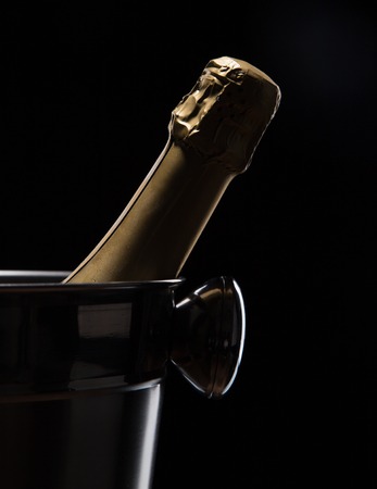 Champagne bucket on black background, celebration theme.の写真素材
