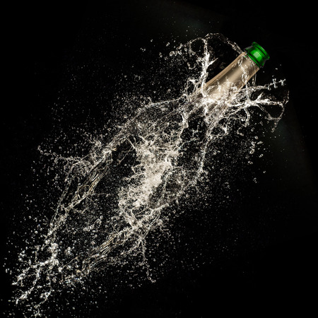Abstract champagne bottle on black background, celebration theme.の写真素材