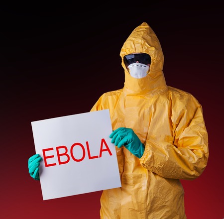 Scientist with protective yellow hazmat suit, ebola concept.の写真素材